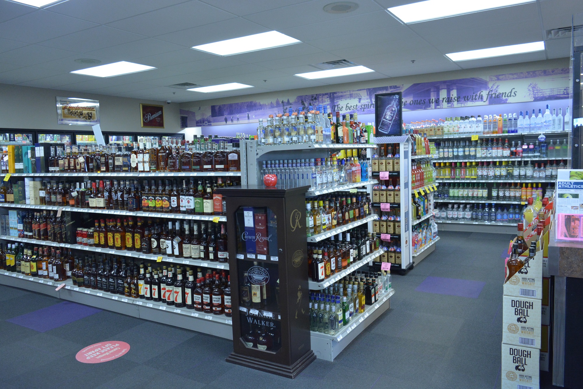 Interior view of Apple Valley Liquor store featuring organized shelving of spirits, whiskey, and vodka.