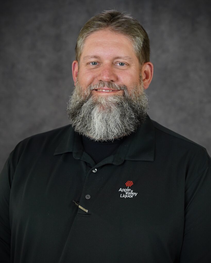 Ben Dockter, Manager Store #3 headshot with Apple Valley Liquor polo