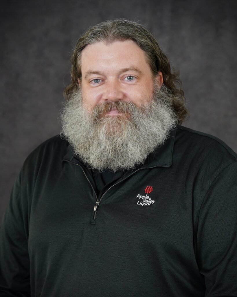 Eion Foote, Liquor Store #3 Assistant Manager headshot with Apple Valley Liquor quarter zip