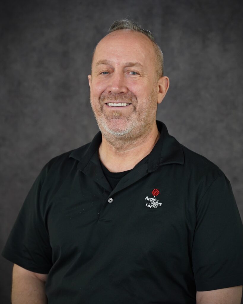 Noel Nichols, Assistant Manager & Wine Specialist Store #3 headshot with Apple Valley Liquor polo