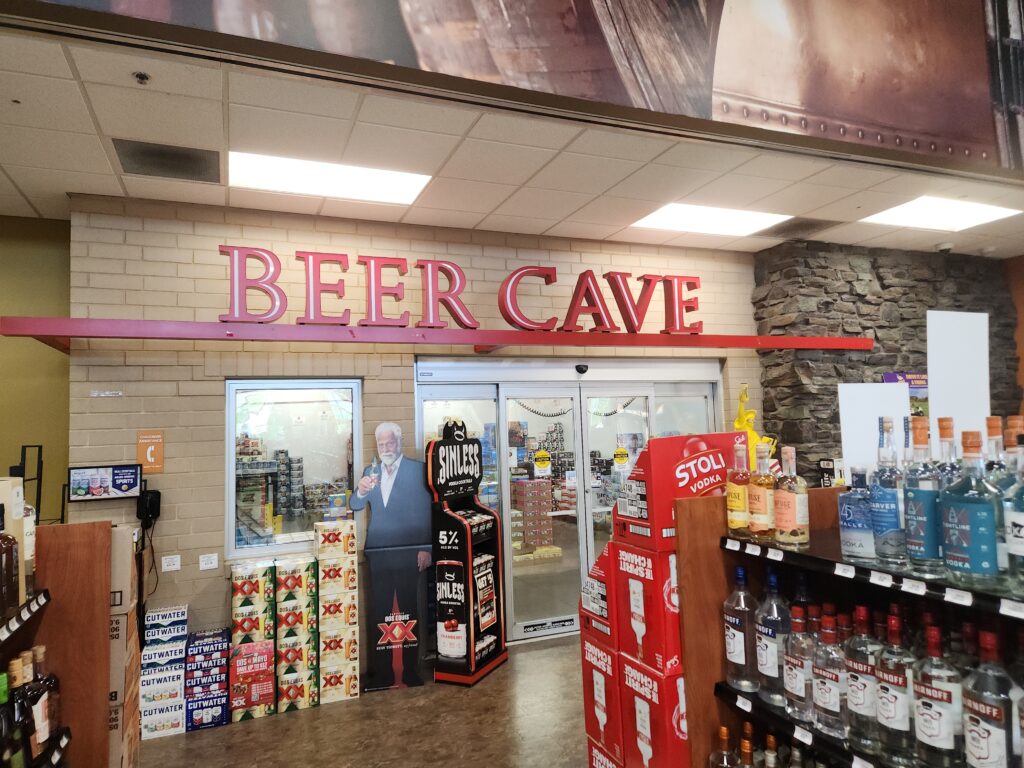 Beer cave signage over the sliding door entrance at liquor store #3